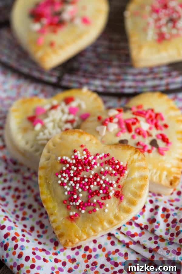 Strawberry Love Bites 5 A tray of freshly baked mini heart-shaped hand pies, cooling and ready to be enjoyed.