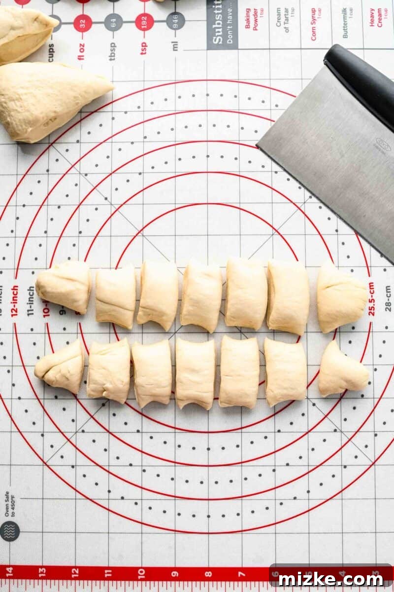Close-up of a measuring board with pretzel dough cut into small, even pieces, highlighting their uniform size.