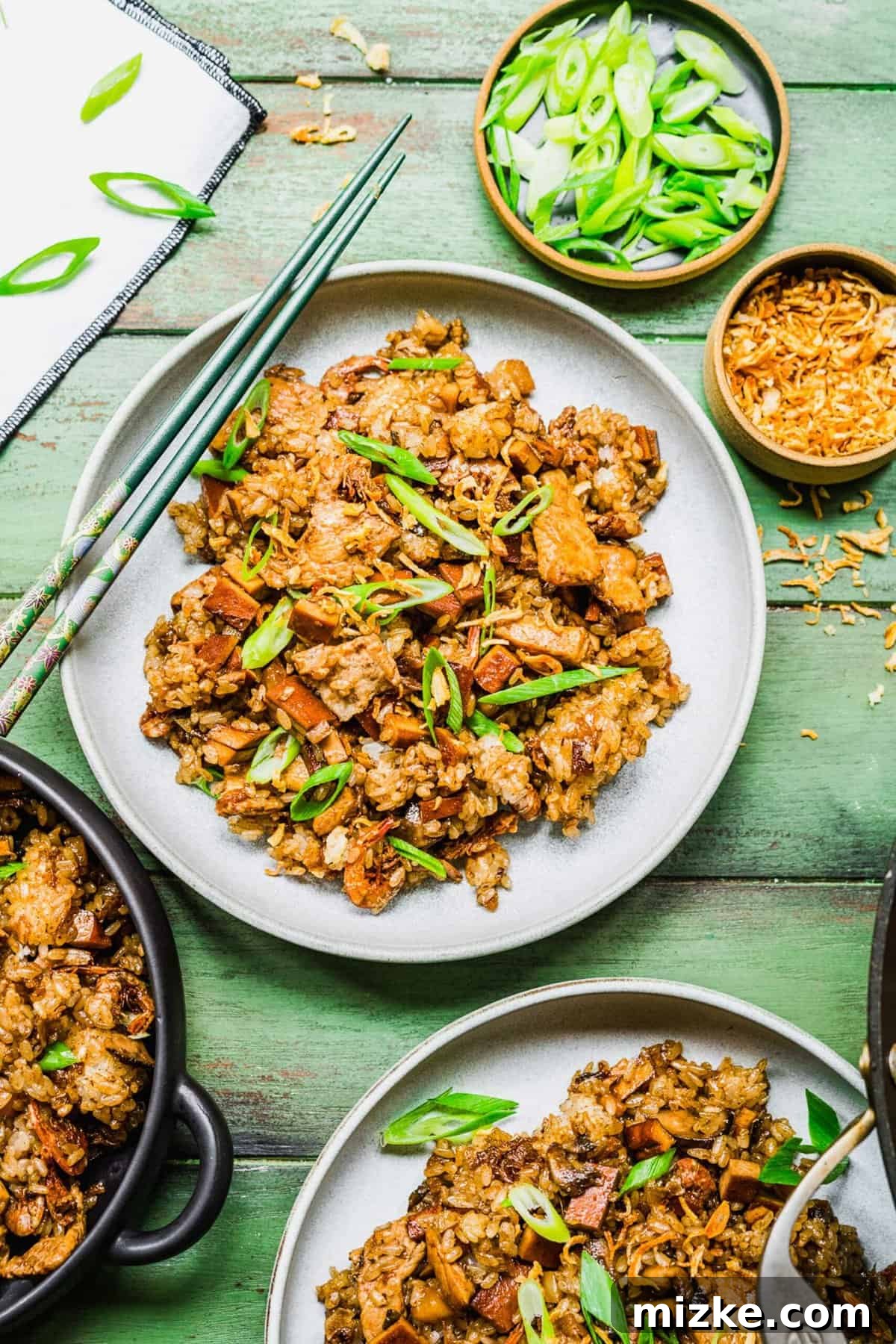 2 plates of sticky rice with bowls of garnishes