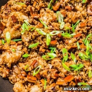 Skillet of sticky rice garnished with scallions