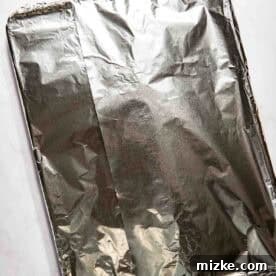 A baking tray covered with aluminum foil.
