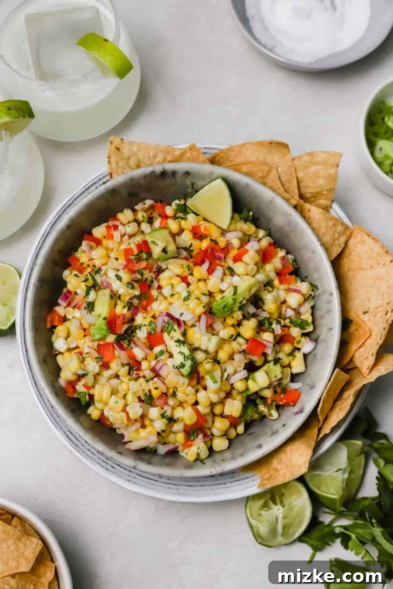 Zesty Corn and Avocado Salsa 2 Vibrant corn and avocado salsa in a bowl, a refreshing side dish or appetizer perfect for summer gatherings and barbecues.