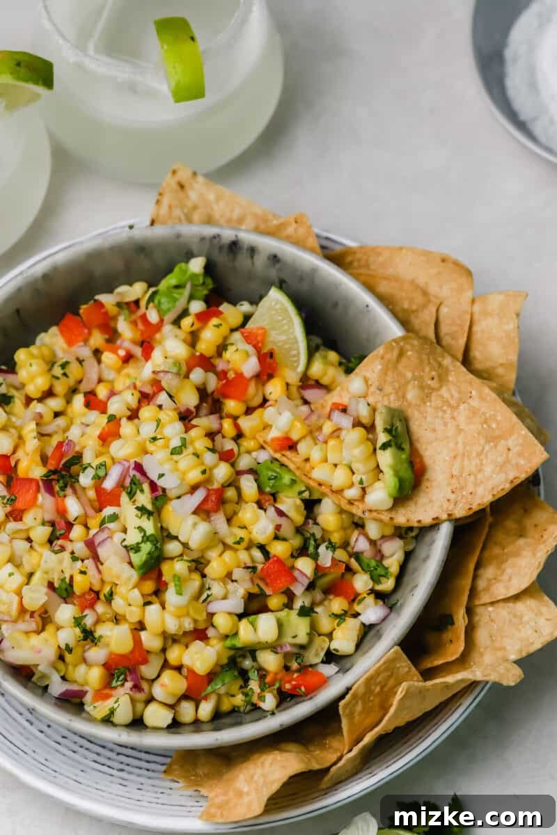 Zesty Corn and Avocado Salsa 3 Close-up of freshly prepared corn and avocado salsa, highlighting the colorful combination of corn, avocado, red onion, and bell pepper, ready for serving.