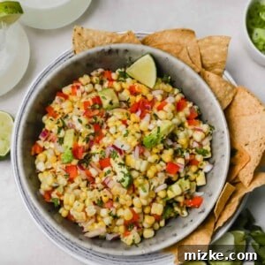 A bowl of vibrant Corn and Avocado Salsa with fresh ingredients, beautifully arranged and ready to be served.