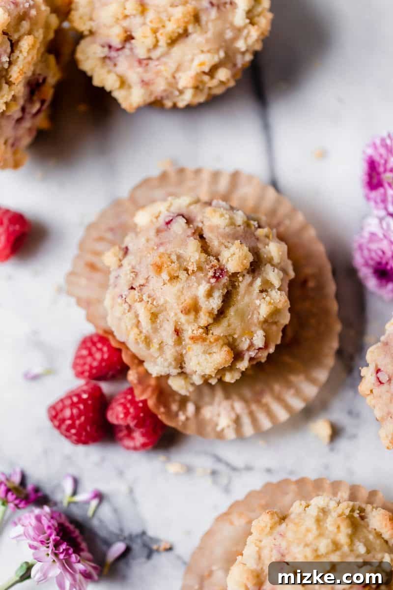 Zesty Lemon Raspberry Streusel Muffins 4 A batch of Raspberry Lemon Streusel Muffins cooling on a wire rack, showcasing their golden streusel tops.