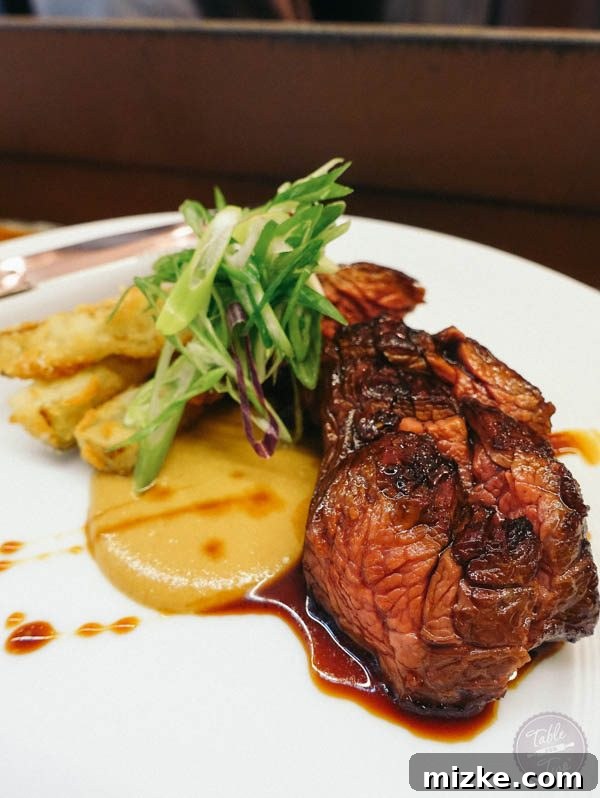 Perfectly cooked hangar steak with horseradish mustard and fried zucchini.