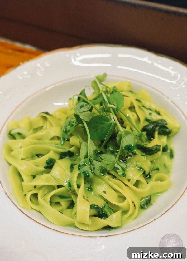 Handmade fettuccine with pea shoots, tarragon, and spring onions.