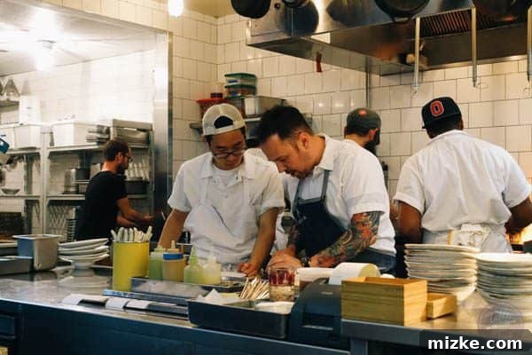 Chef Aaron Silverman interacting with his team in the Rose's Luxury kitchen.