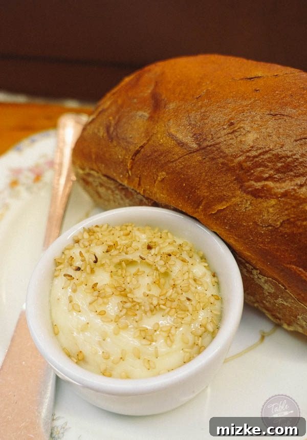 Freshly baked bread with honey sesame butter at Rose's Luxury.