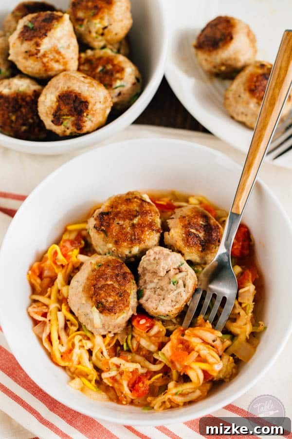 Large batch of moist zucchini turkey meatballs, perfect for freezing and healthy meal prep.