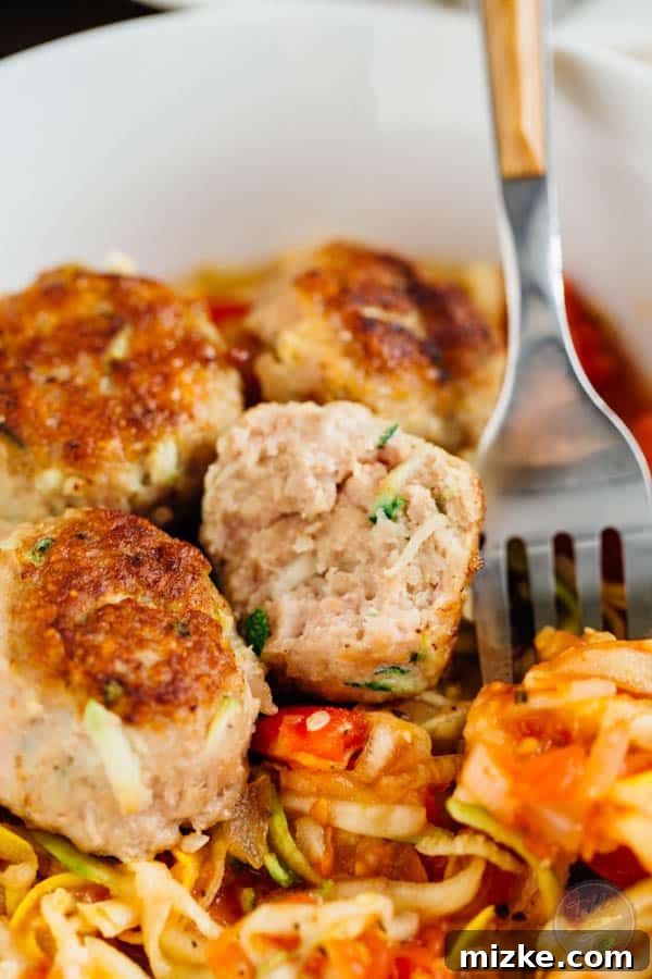 Close-up of savory zucchini turkey meatballs with fresh parsley, ready to be served.