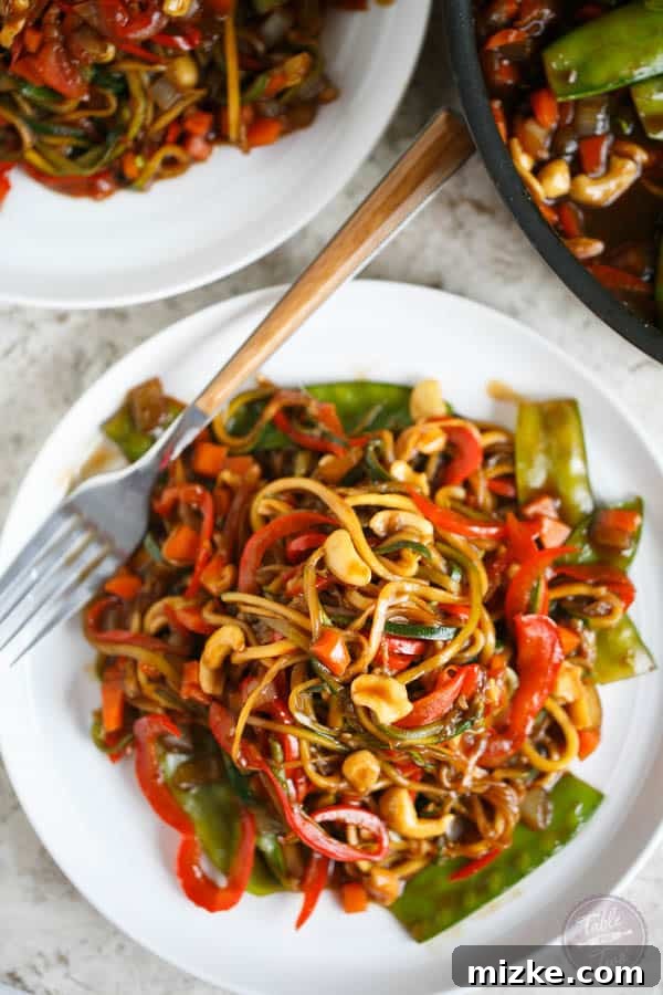Vibrant Zoodle Cashew Stir Fry 4 Spiralized zucchini noodles and bell peppers ready for the wok, showcasing the fresh ingredients for a healthy stir fry.