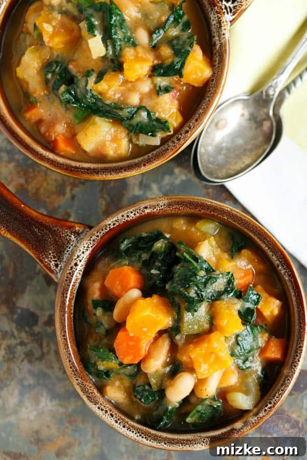 Golden Butternut White Bean Kale Stew 4 A close-up shot of creamy butternut squash, white bean, and kale stew, highlighting its vibrant colors and rich texture. A perfect vegan comfort food.