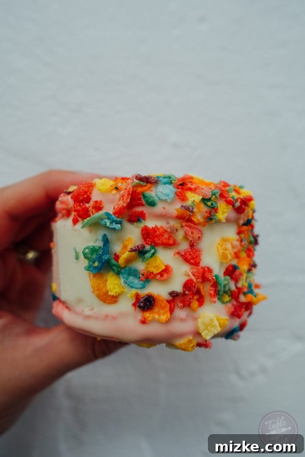 Close-up of a fruity pebbles ice cream macaron sandwich from MILK, a delightful and unique dessert.