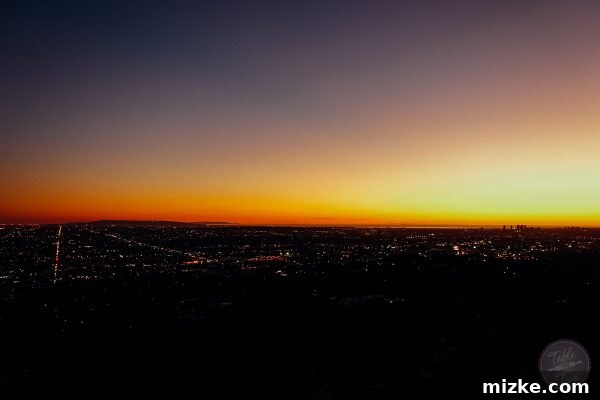 City lights of Los Angeles stretching into the distance from Griffith Observatory at dusk.