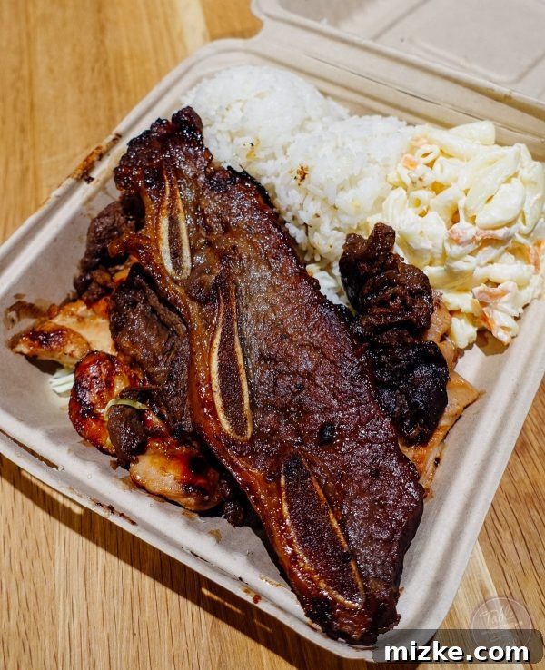 A hearty L&L Hawaiian BBQ mix platter with beef, chicken, and short ribs, a true comfort meal.