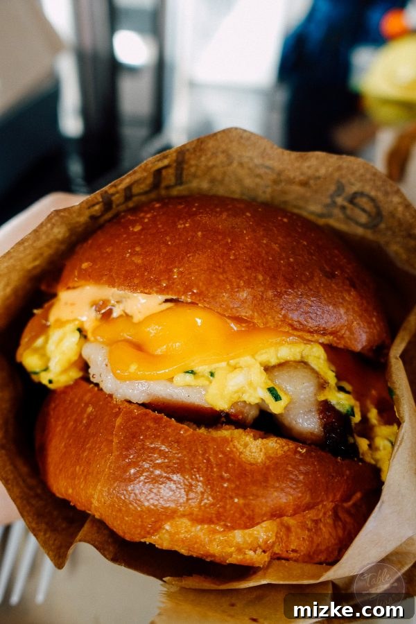 The iconic Fairfax sandwich from Eggslut, a gourmet breakfast delight with scrambled eggs and sriracha mayo.