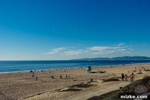 Sun-drenched sands of Manhattan Beach with the pier in the distance, inviting relaxation.