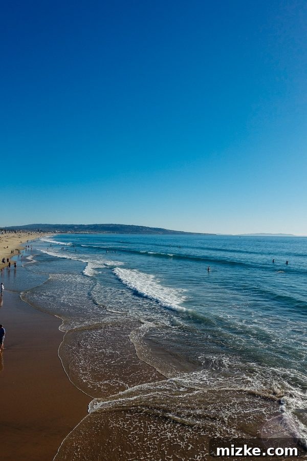Vibrant lifeguard stand on Manhattan Beach, emblematic of California's coastal lifestyle.