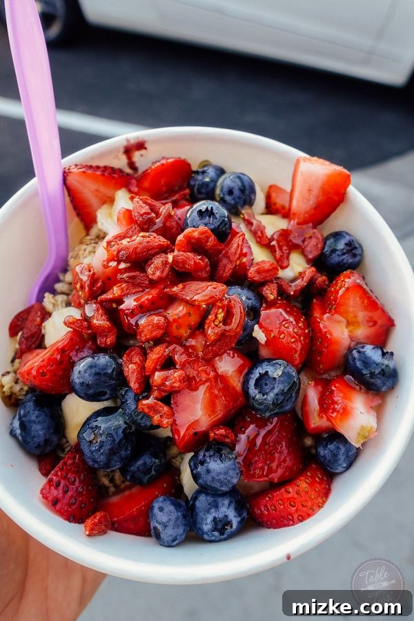 Fresh and vibrant acai bowl topped with granola, fruit, and coconut flakes, a popular LA treat.