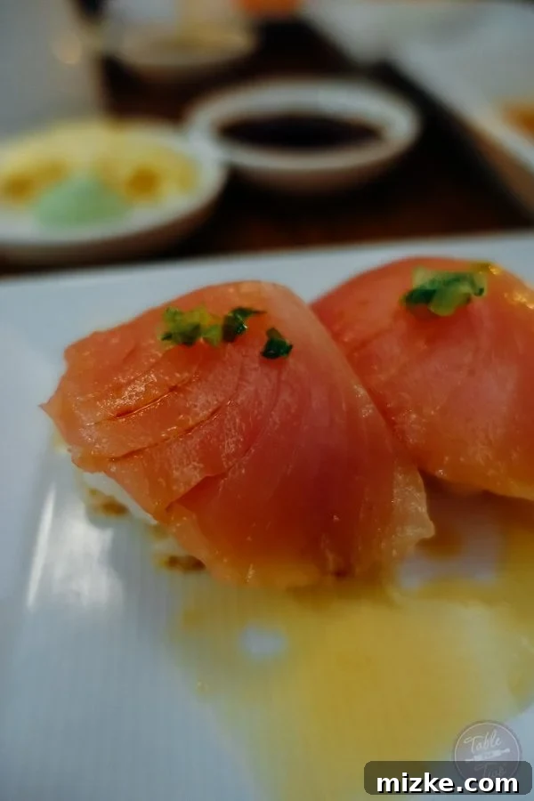 Close-up of a beautifully crafted sushi roll from SUGARFISH, highlighting intricate details.