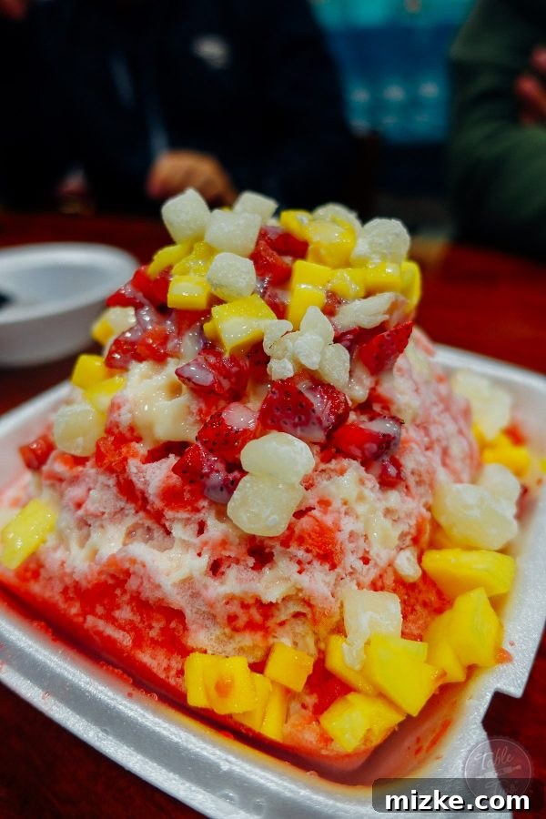 A massive and delicious shaved ice with ice cream from Aloha Pizza and Shave Ice Company, perfect for sharing.