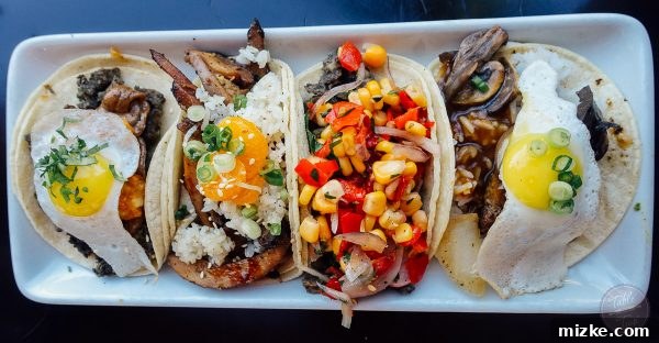 Assortment of delicious Asian fusion tacos from Komodo, showcasing a variety of fillings and toppings.