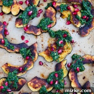 Golden Roasted Acorn Squash with Zesty Arugula Pesto and Pomegranate Gems 5 Roasted acorn squash with arugula pesto and pomegranate is a great side dish addition to any meal! You'll love how vibrant and colorful this side dish looks on your table!
