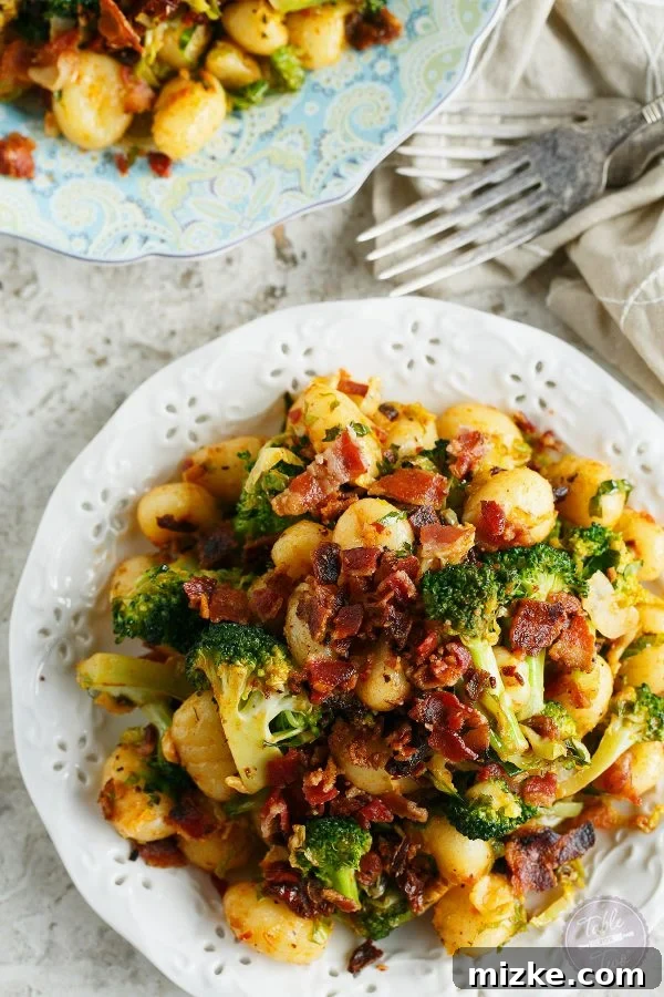 25-Minute Crispy Bacon Gnocchi with Roasted Broccoli & Shaved Brussels 3 Close-up of crispy bacon bits intertwined with tender gnocchi, fresh broccoli florets, and thinly shaved Brussels sprouts, perfect for a quick dinner.