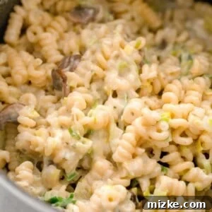up close image of spiral pasta with creamy boursin cheese throughout