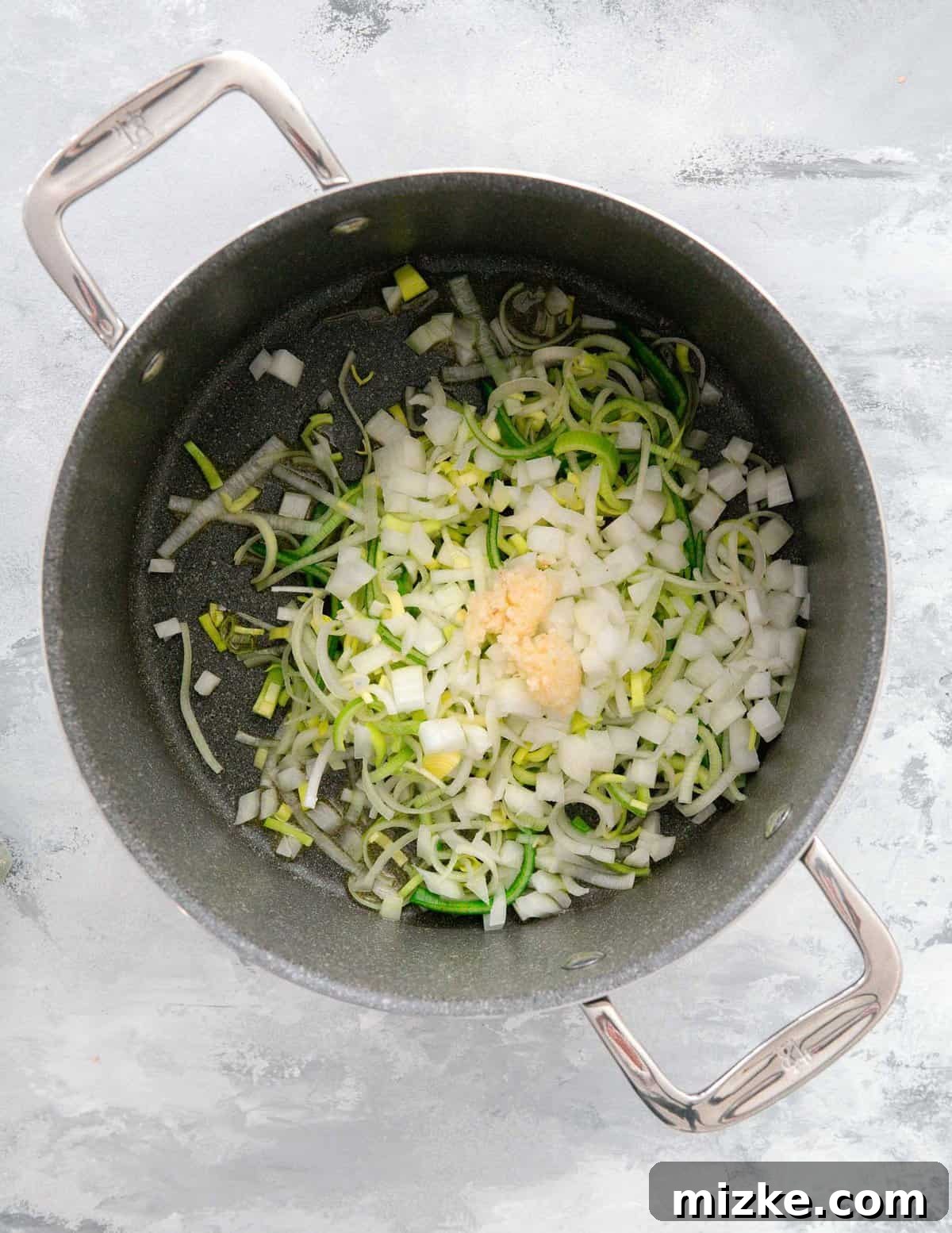 Velvety Mushroom and Leek One-Pot Pasta 6 Sliced leeks, diced onions, and minced garlic being added into a large pot to sauté.