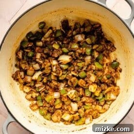 Smoky Southwest Chicken Chili 6 Green bell peppers, onions, and seasonings mixed in a dutch oven