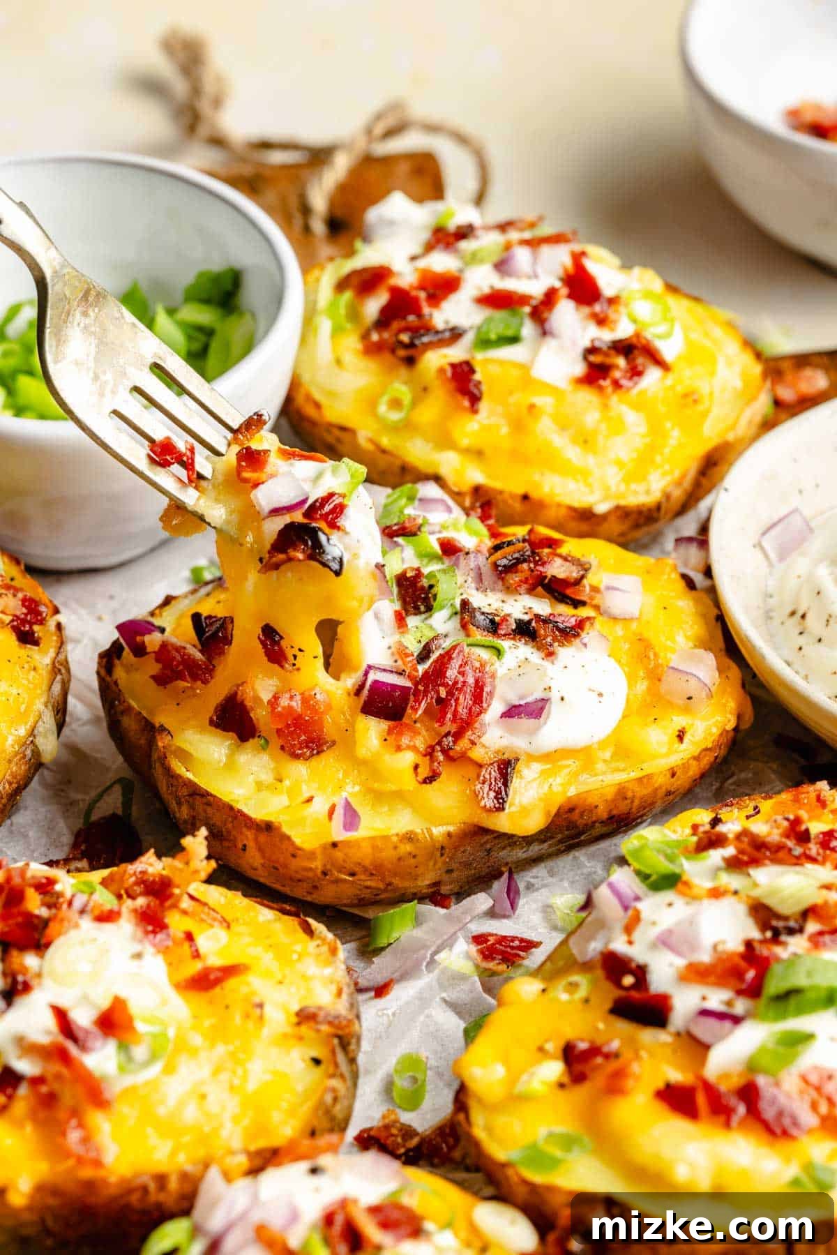 Loaded Double-Baked Potatoes 6 A fork lifting a perfect bite-sized piece of creamy, cheesy potato from a twice baked potato, showing its delicious texture.