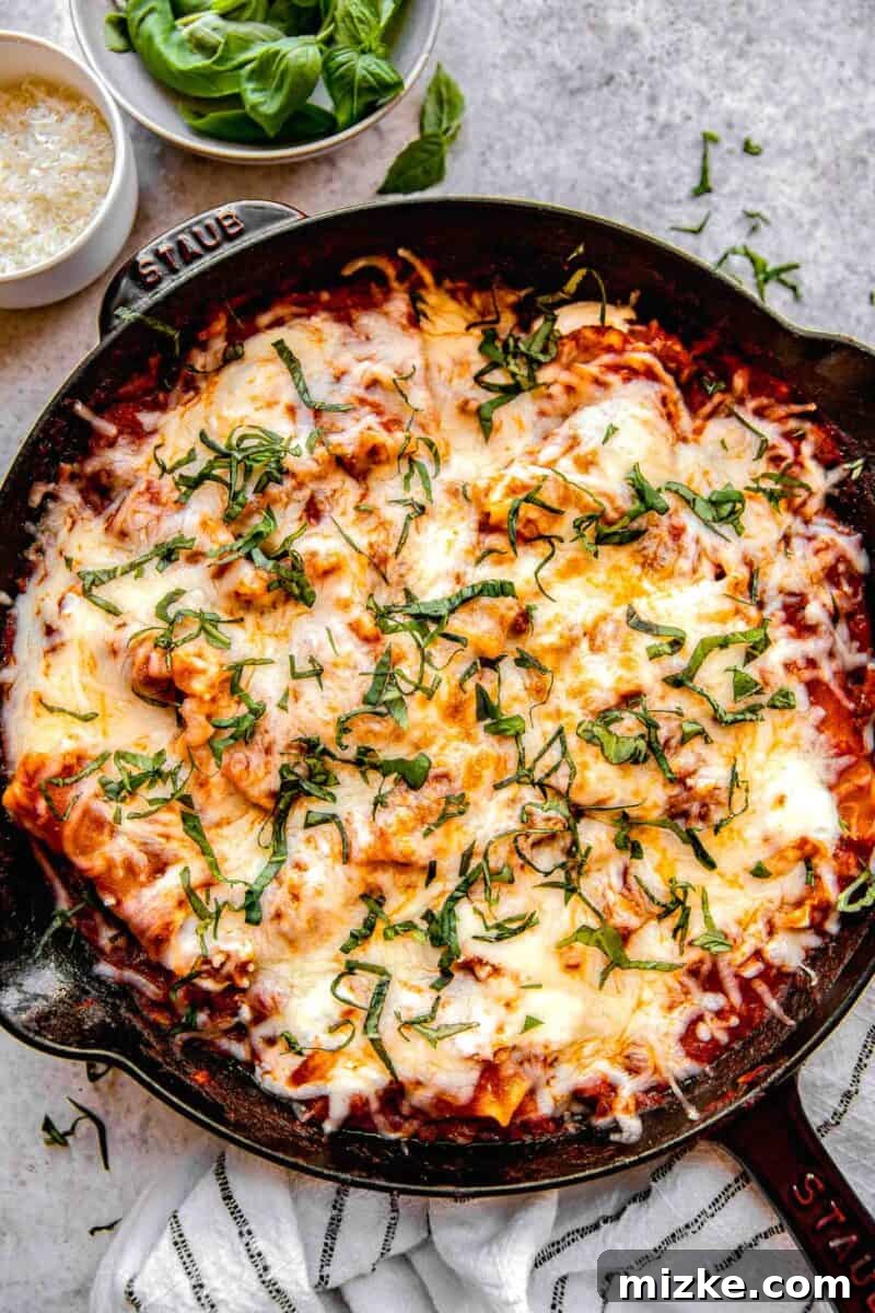 An overhead view of the finished skillet lasagna, garnished with fresh basil.