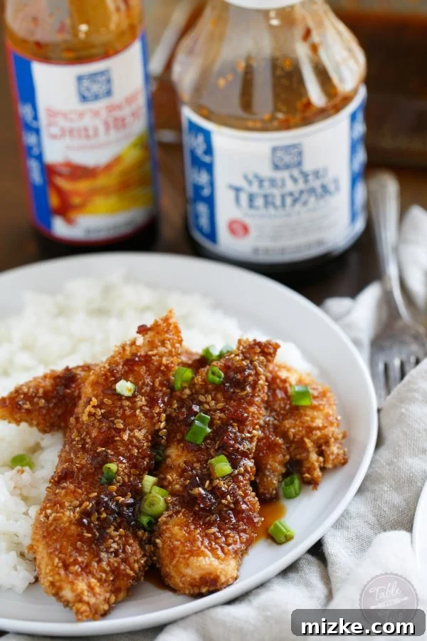 Sweet Heat Crispy Chicken Strips 3 Close-up of golden-brown Crispy Sweet and Spicy Chicken Tenders, highlighting their crunchy texture. A perfect topping for rice, made with Soy Vay.