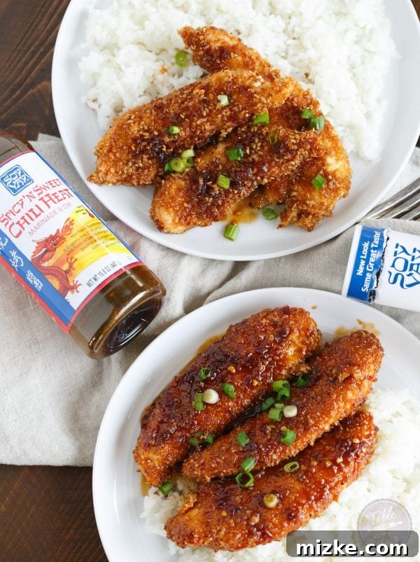 Sweet Heat Crispy Chicken Strips 5 Overhead shot of the finished Crispy Sweet and Spicy Chicken Tenders and rice, with a sprinkle of fresh green onions. Highlight of a quick and flavorful dinner.