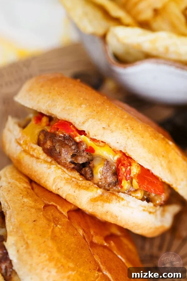 A close-up of a single Hot Pepper Garlic Chorizo Cheeseburger, featuring a perfectly melted slice of cheese over a juicy patty, with vibrant hot pepper pieces visible.