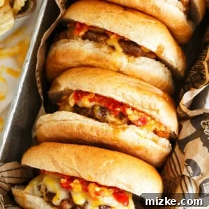 The star of the show: A perfectly assembled Hot Pepper Garlic Chorizo Cheeseburger, showcasing a generous patty, melted cheese, and a hint of spicy sauce peeking out.
