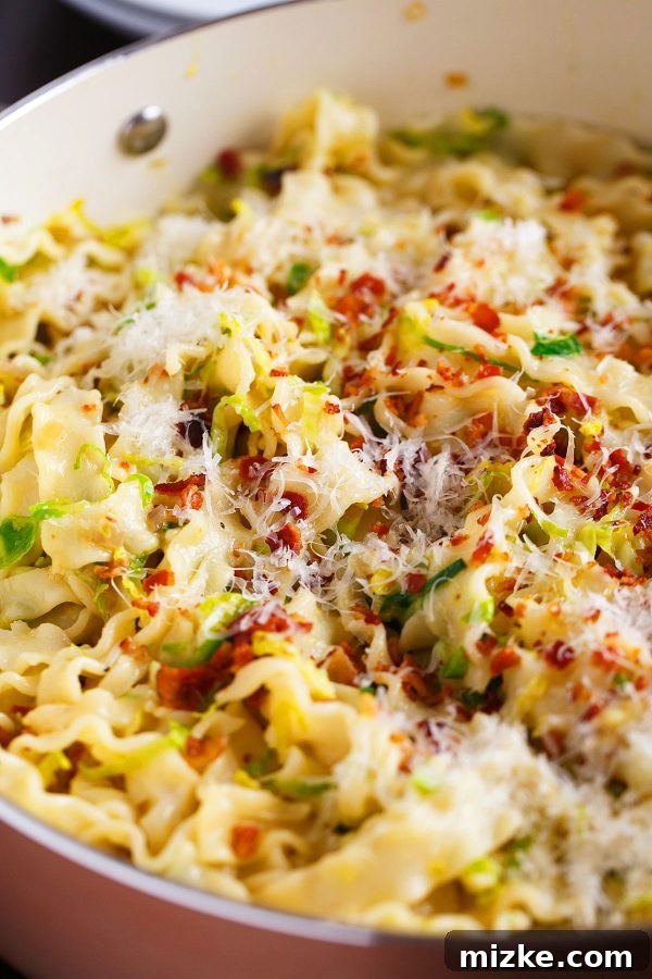 Savory Bacon and Brussels Sprouts Carbonara 2 A close-up shot of a plate piled high with creamy bacon and brussels sprouts pasta carbonara, garnished with fresh parsley.