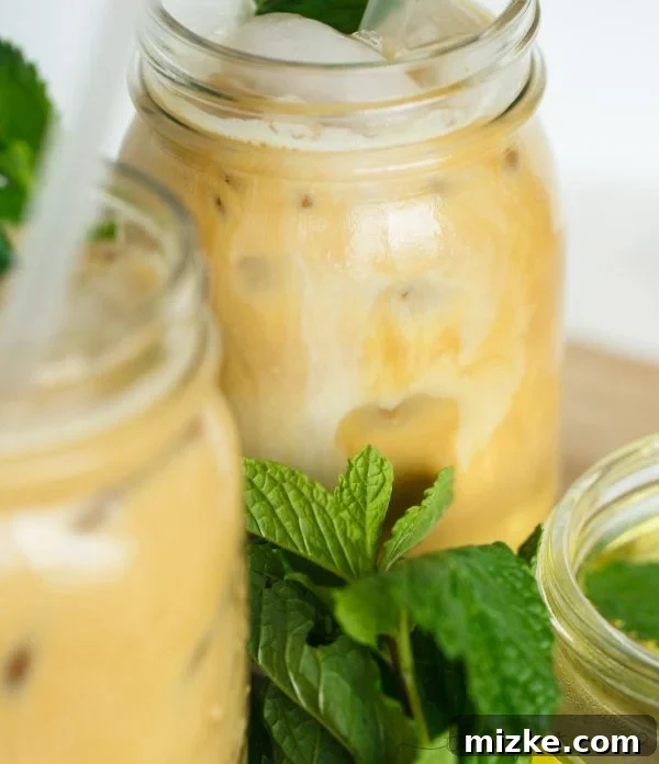 Mint Chill Latte 4 Close-up of a glass Iced Mint Latte, showcasing the layers of milk, espresso, and the refreshing green tint from mint, ready to be enjoyed.