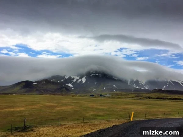 Scenic view of the coastal town of Vík í Mýrdal, Iceland, with black sand beaches and rugged cliffs