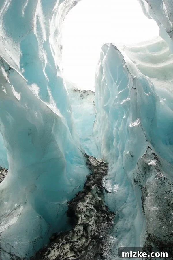 Five Days in Iceland The Vík Experience 11 Glacier guide pointing out details inside an ice cave to a group of curious tourists