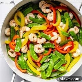 Sizzling Shrimp Noodle Delight 6 bell peppers, snow peas, and shrimp in a large nonstick skillet