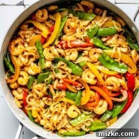 Sizzling Shrimp Noodle Delight 7 stir fry sauce added to and tossed with rice noodles, shrimp, and vegetables