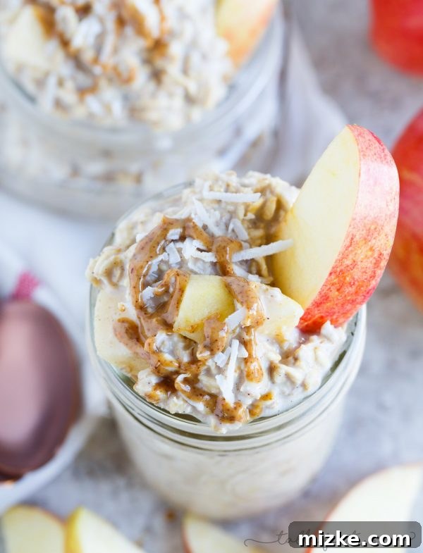 Spiced Apple Crumble Overnight Oats 4 A visually appealing shot of Apple Pie Overnight Oats, with a spoon ready to dive in, illustrating the creamy texture and inviting presentation of this simple and satisfying breakfast.