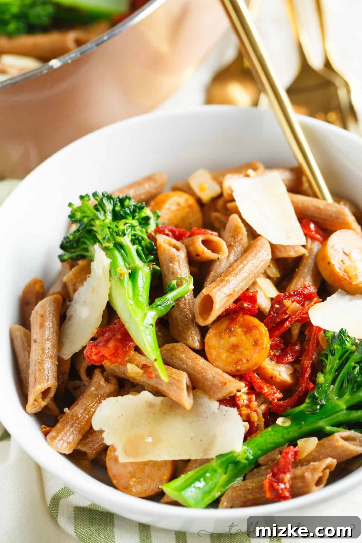 Wholesome Penne with Savory Chicken Sausage, Zesty Sun-Dried Tomatoes, and Bitter Greens 5 A light and hearty pasta dish that will sure to fill you up! This whole wheat penne with broccoli rabe, chicken sausage, and sundried tomatoes is a flavorful and unique pasta dish to put on your dinner table!