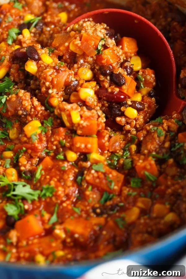Wholesome One-Pot Turkey Quinoa Chili 4 Stovetop turkey quinoa chili ready to be served, topped with fresh herbs and a side of crunchy tortilla chips.