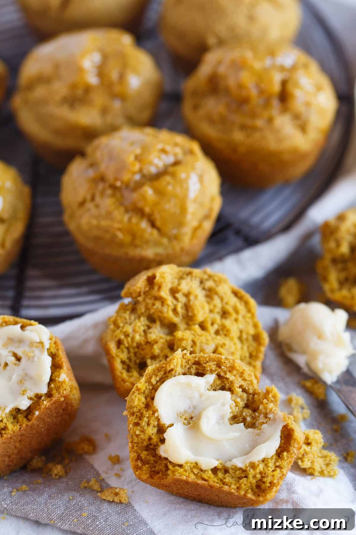 Autumn Spiced Pumpkin Cornbread Muffins 2 Closeup of a warm Pumpkin Cornbread Muffin sliced in half, generously slathered with rich, creamy maple butter.