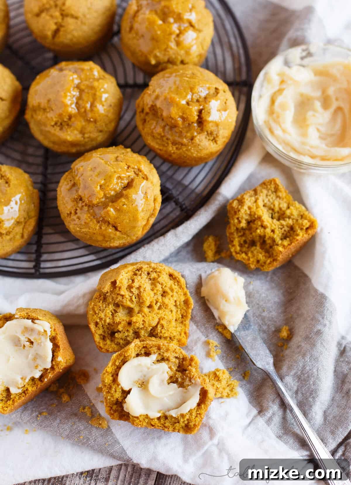 Autumn Spiced Pumpkin Cornbread Muffins 5 An inviting overhead shot of several golden-brown Pumpkin Cornbread Muffins arranged artfully, showcasing their rustic texture and appealing color.