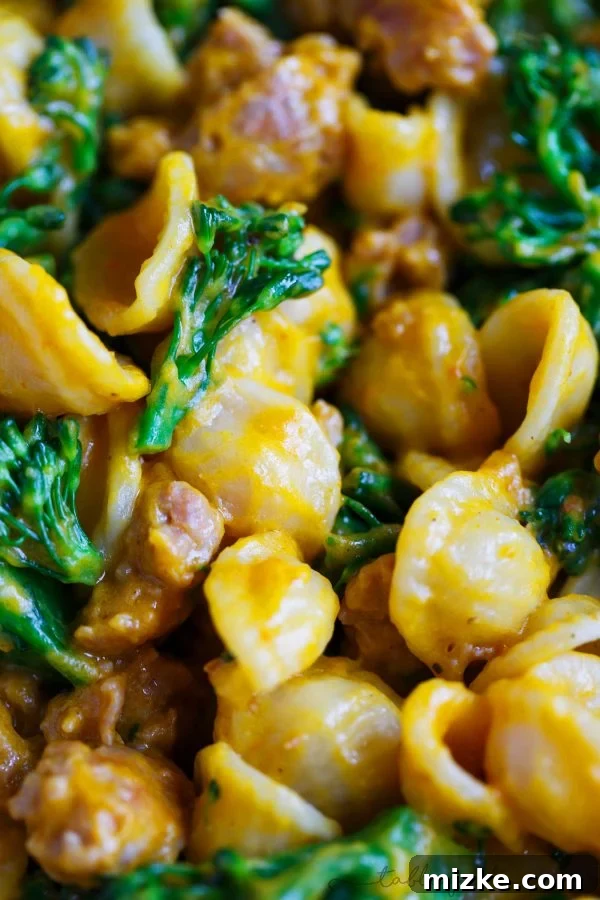 Golden Pumpkin Mascarpone Orecchiette with Zesty Sausage and Broccolini 5 A serving of pumpkin mascarpone orecchiette pasta in a rustic white bowl, ready to be enjoyed as a comforting fall meal.